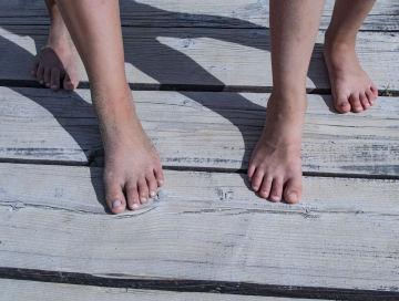Feet on the wooden pier
