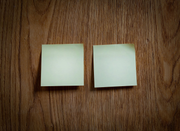 Square Notes from a Notebook on a Wooden Wall