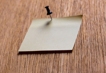 A small card attached with a pushpin