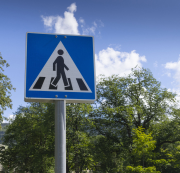 Pedestrian crossing road sign