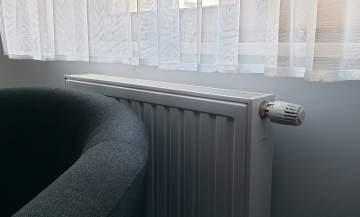 Room interior with a radiator and armchair