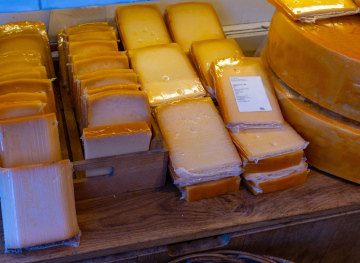 Pieces of hard cheese in the store